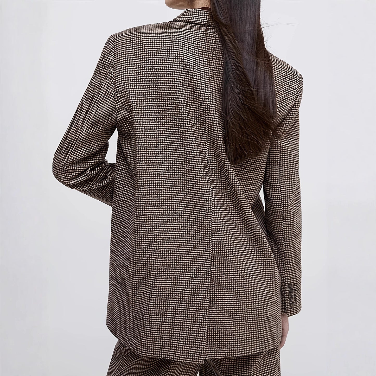 Women wearing a brown checkered suit against a white background