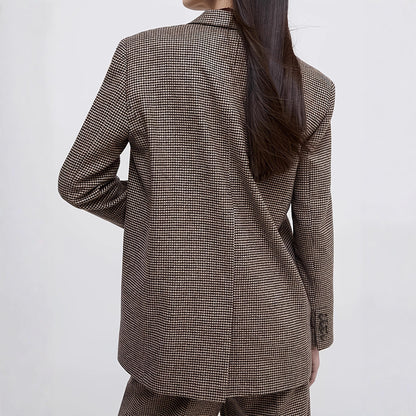 Women wearing a brown checkered suit against a white background