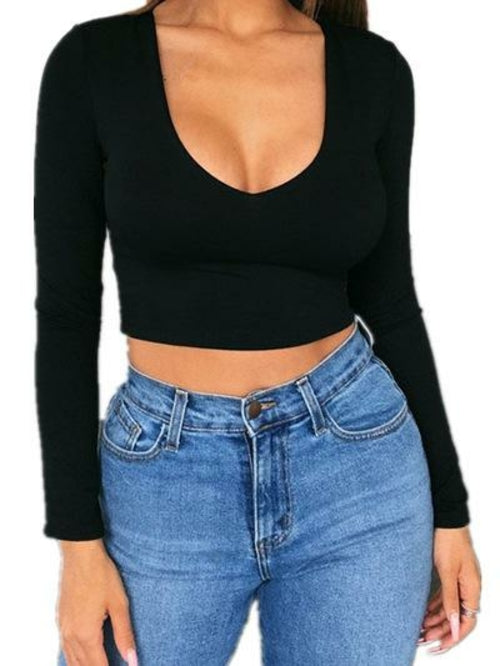 Woman's wearing a black long-sleeve crop top and blue jeans on a white background