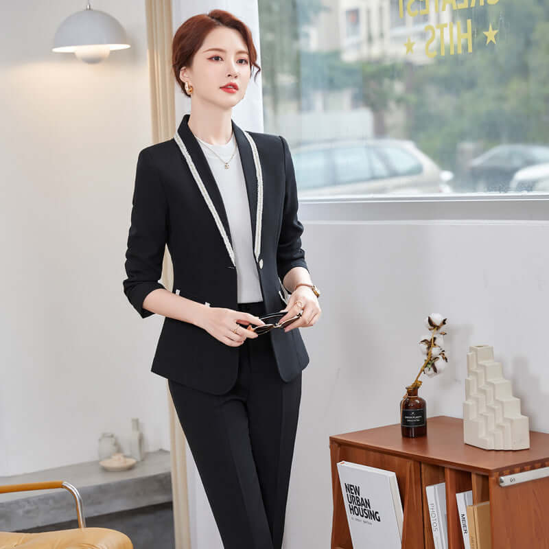 Woman in a black suit standing in an office setting