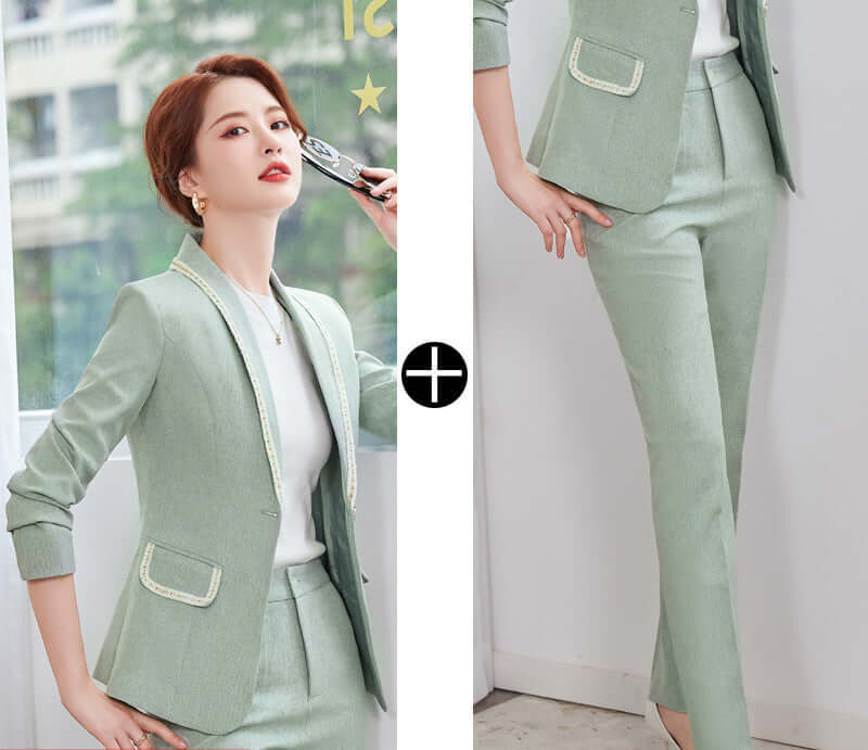 Woman wearing a light green suit with a white shirt, standing indoors.