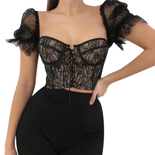 Black lace top worn by a model on a white background