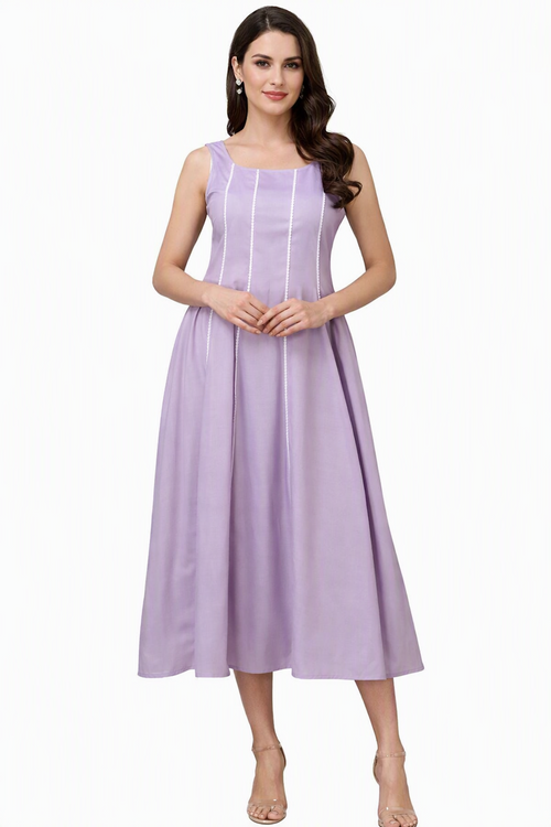 A woman modeling a sleeveless lavender midi dress with thin vertical white stripes, photographed against a plain white studio background.