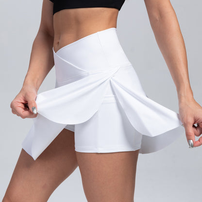 White tennis skirt worn by a person on a light gray background