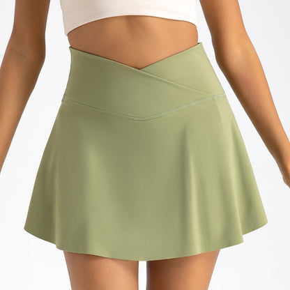 Green skirt worn by a woman on a plain background