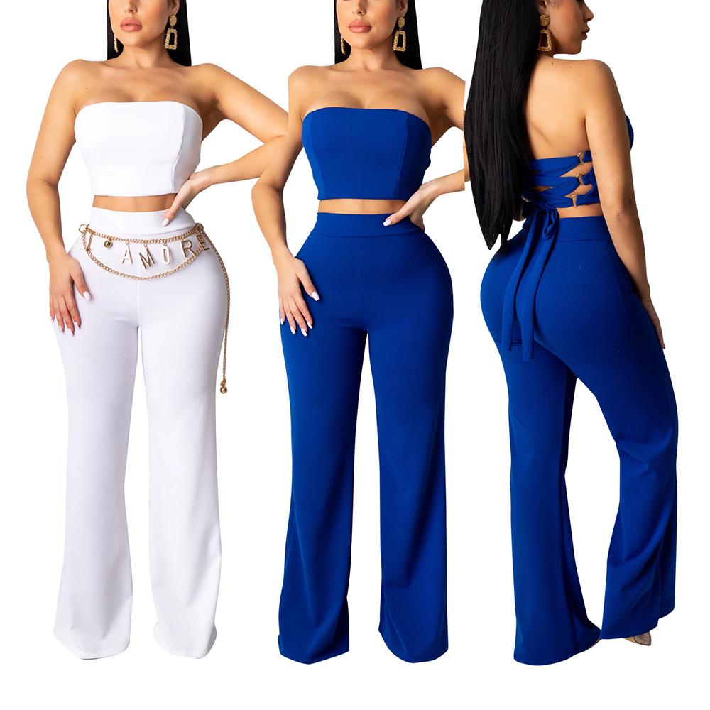 Three women wearing strapless tops and high-waisted pants in white and blue on a white background.